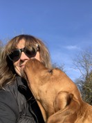 Michelle smiling while holding her dog.